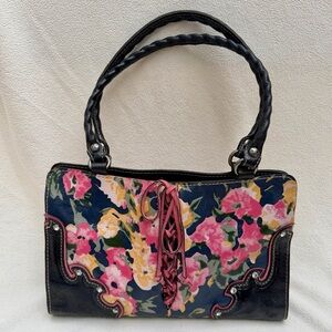 PATRICIA NASH vintage leather bag. Floral print and corset-style front lacing.